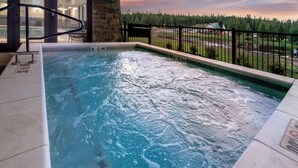 A hot tub with a view of a forest and a road. - SpringHill Suites by Marriott Island Park Yellowstone (Island Park)