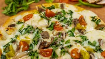 A pizza with various toppings.