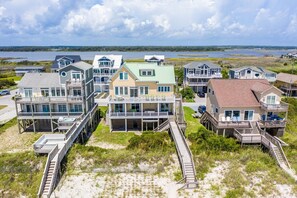 A coastal residential area with houses featuring balconies and waterfront views.