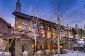 A stone building with a wooden balcony and stone pillars.