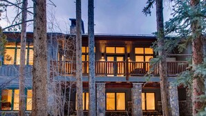 A multi-story lodge with stone pillars, wooden balconies, and large windows. - Beaver's Lodge (Breckenridge)