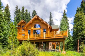 A log cabin with a balcony, surrounded by trees. - Clifton Lodge (Breckenridge)