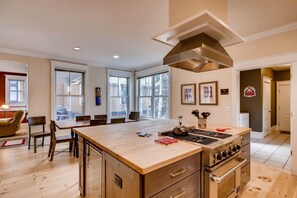 Enjoy cooking in this well-lit kitchen with a large island, stove, and oven, plus a cozy seating area.
