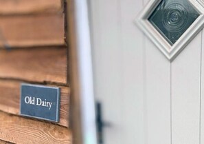 A wooden wall with a sign that reads "Old Dairy." - Rowley Farm Holidays (Worcester)
