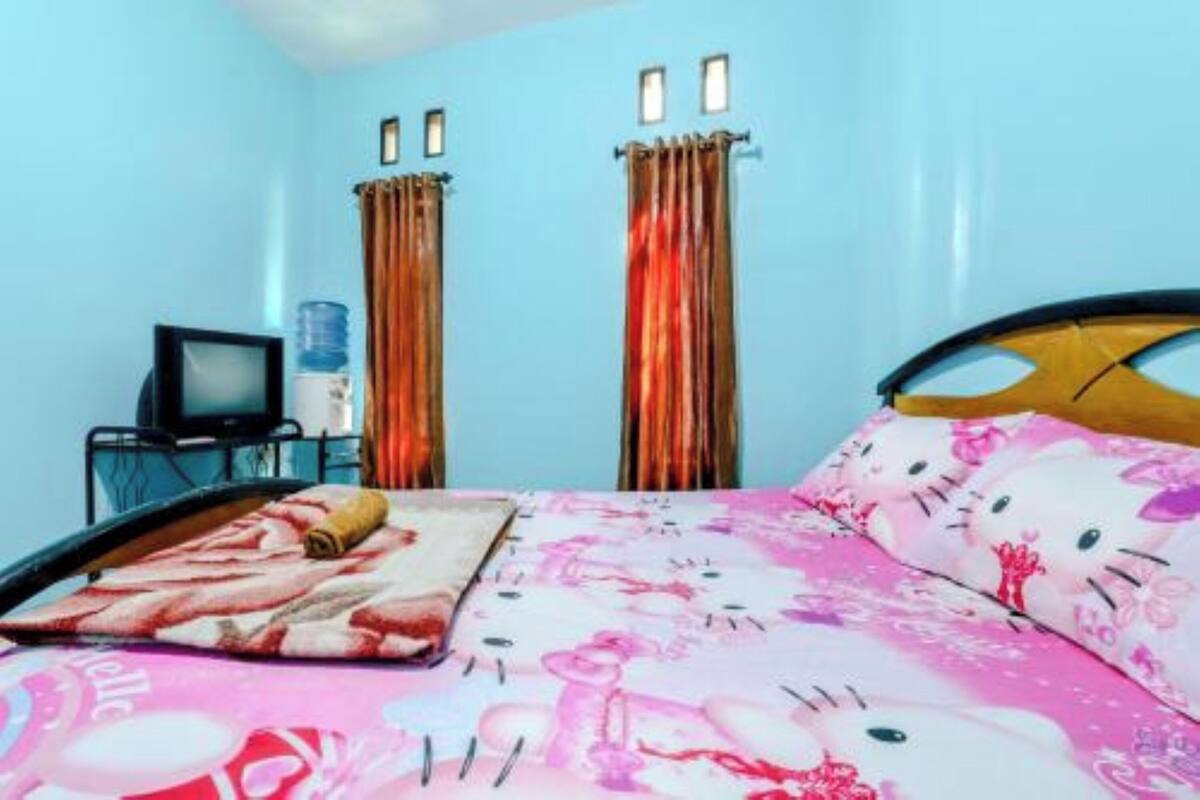 A room with a bed, a television, curtains, and a water dispenser.