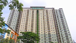 A high-rise building with multiple balconies and a sign reading "the Suites".