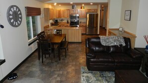 A modern kitchen with wooden cabinets, stainless steel appliances, and a central island. - Anderson Island's most peaceful home (Anderson Island)