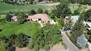 A large house with a spacious lawn, a driveway, and a garage. - Walla Walla Wine Country Estate (Walla Walla)