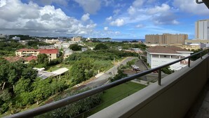 A cityscape with buildings, roads, and greenery. - Pia Resort Hotel Standard 2 Bedroom 1 (Tamuning)