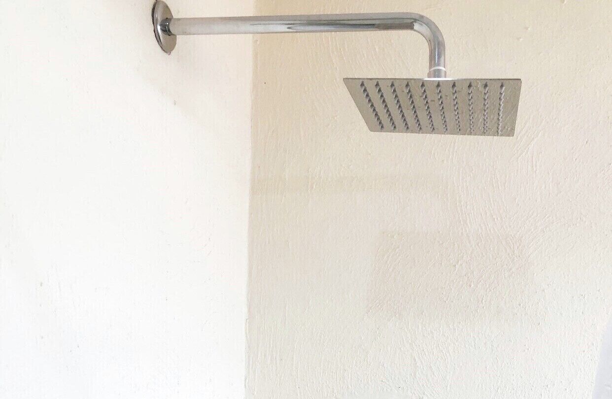 A showerhead mounted on a wall.