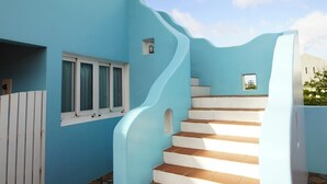 A blue building with a spiral staircase leading to a window. - Kenting Wonderful Hotel (Hengchun)