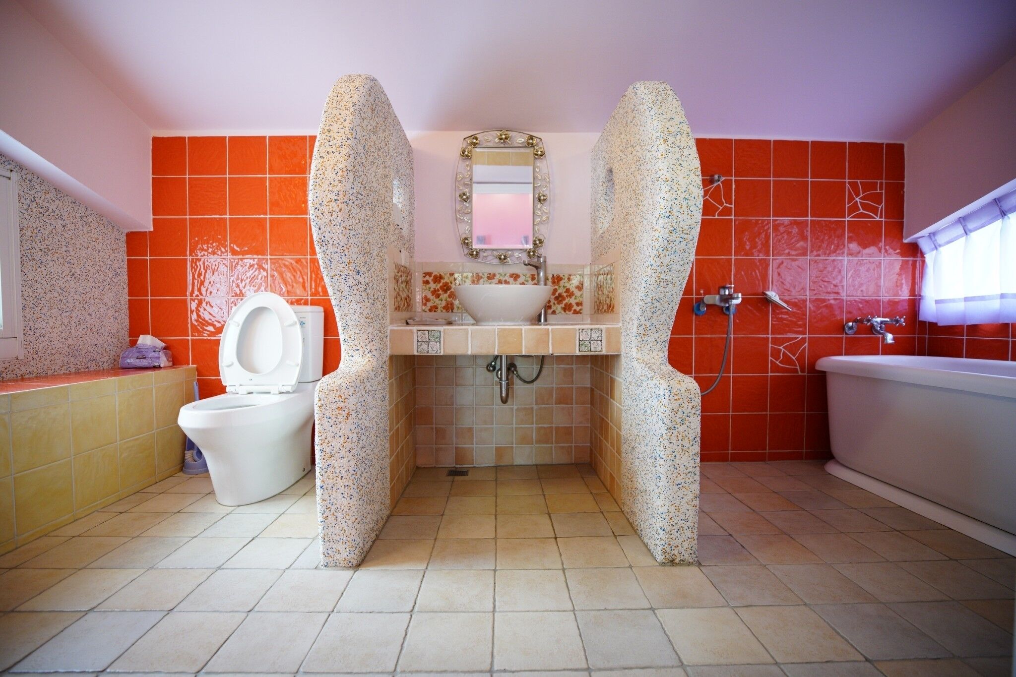 A bathroom with a white toilet, a sink, and a bathtub.