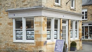 A stone building with a sign for 'Cotswolds Hideaways' offering country holiday retreats. - Fairfields, Moreton-in-Marsh, sleeps 6 guests  in 3 bedrooms (Moreton-in-Marsh)