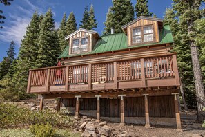 A wooden cabin with a balcony, surrounded by trees. - Little Bear Cabin by Hauserman Rentals (Tahoe Vista)