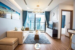 Family Apartment | Living room | 50-inch Smart TV with satellite channels, TV - TCOO Luxury Apartment (Hanoi)