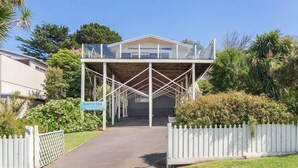 A covered walkway leading to a building with a sign reading "SURF@188". - Surf188 - sleeps up to 16 (SMITHS BEACH)