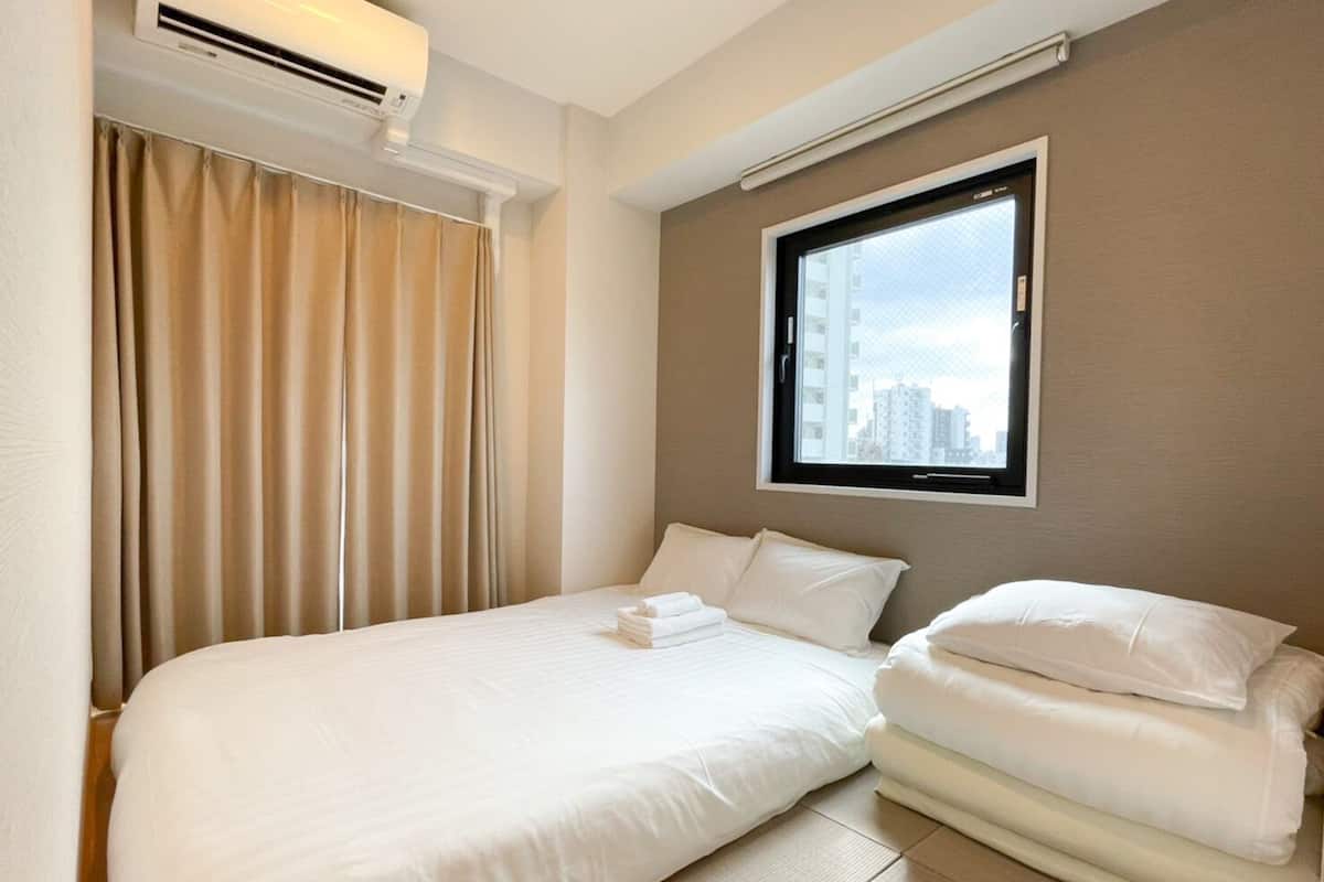 Ein Hotelzimmer mit Bett, Fenster und Klimaanlage.