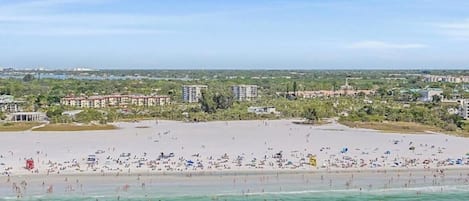 A beach with a wide sandy area and a clear view of the ocean.