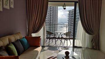 Premium Family Suite, 3 Bedrooms | Living room | Flat-screen TV