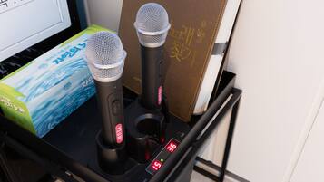 A black electronic device with two microphones and a digital display.