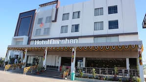A hotel named "Hotel Darshan" with a modern facade, multiple windows, and a well-decorated entrance. - Hotel darshan naroda (Ahmedabad)