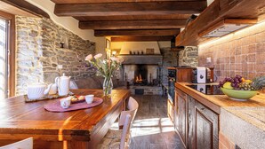 A rustic kitchen with stone walls, a wooden ceiling, and a fireplace. - Canto del fiume, Raggiolo, Tuscany, surrounded by nature  (RAGGIOLO)