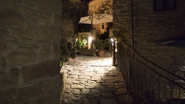A narrow stone pathway leading to a building with a stone facade, a metal railing, and potted plants. - Canto del fiume, Raggiolo, Tuscany, surrounded by nature  (RAGGIOLO)