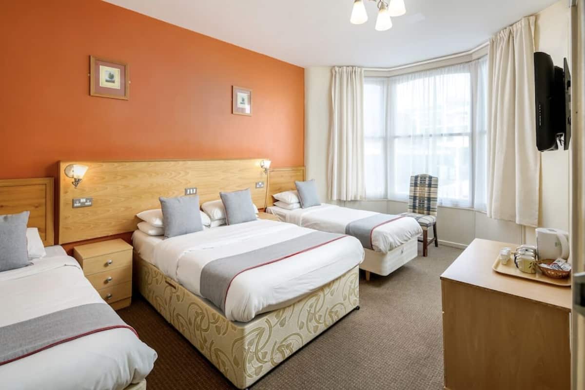 Classic Quadruple Room | Laptop workspace, blackout drapes, iron/ironing board, WiFi (free)