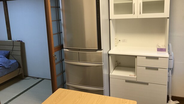 A compact room with a bed, a refrigerator, a microwave, and a cabinet with drawers. - Michio's House (Ebina)