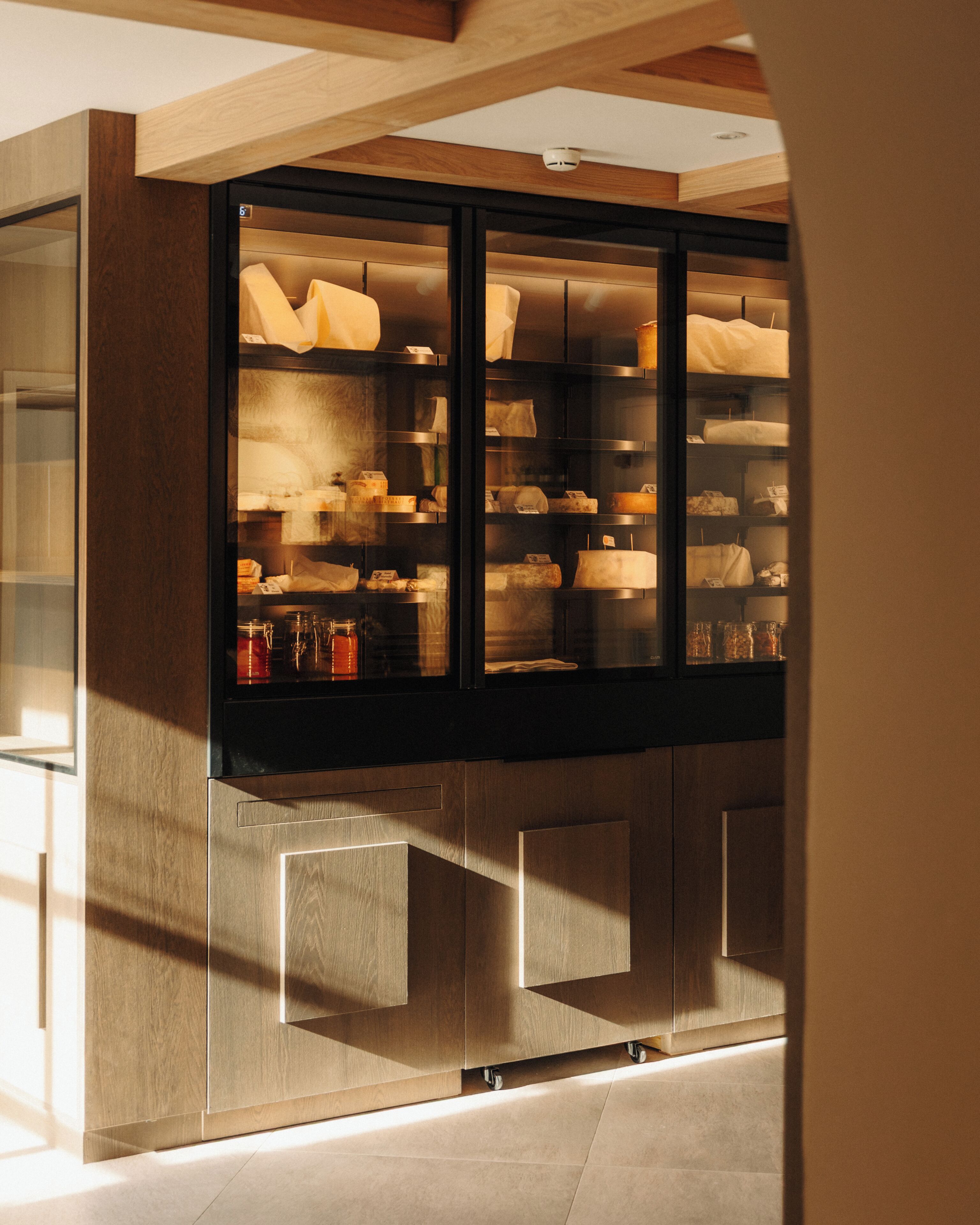 A modern interior with a glass display case containing various items.