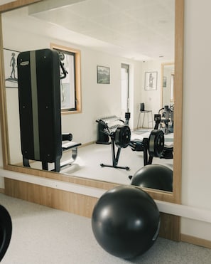 A gym with exercise equipment, a mirror, and exercise balls. - Domaine de Dolomieu, BW Premier Collection (Dolomieu)