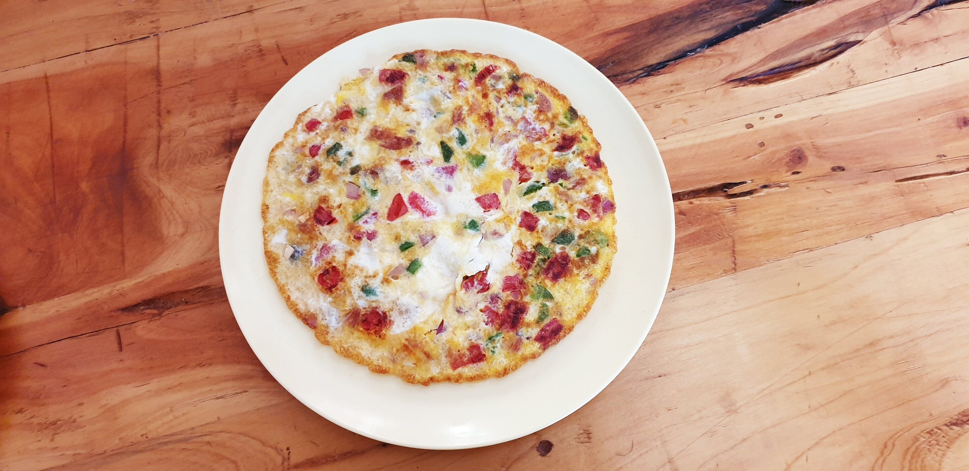 A plate of food on a wooden table.