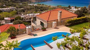 A residential property with a swimming pool, a red-tiled roof, and a view of the sea. - Kissamos rental villa with private pool (Kissamos)