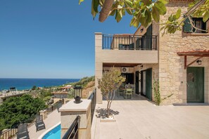 A two-story building with a balcony overlooking a coastal view. - Sea View Villa with Private Pool | West Crete (Kissamos)