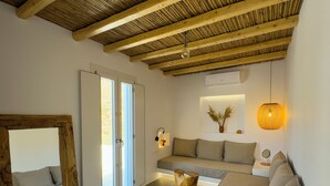 A modern living room with a wooden ceiling, a sofa, a coffee table, and a mirror.
