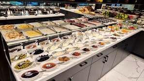A buffet with various food items and condiments. - Port Rivoli Baku Hotel (Baku)