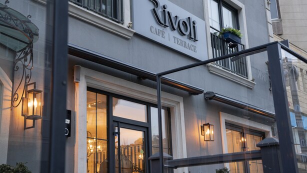 A building with a sign reading "Rivoli Café | Terrace".