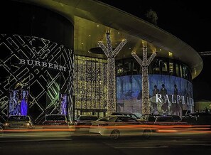 A modern building with illuminated signage for Burberry and Ralph Lauren. - Port Rivoli Baku Hotel (Baku)