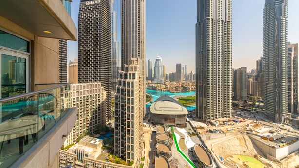A high-rise building with a modern architectural design, featuring a glass facade and a prominent vertical structure.