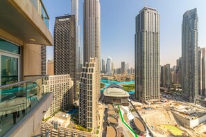 A high-rise building with a modern architectural design, featuring a glass facade and a prominent vertical structure. - Maison Privee - Central Dubai Apt w/Danish Twist & Burj Khalifa Vws (Dubai)
