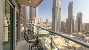 A balcony with a view of high-rise buildings and a construction site.