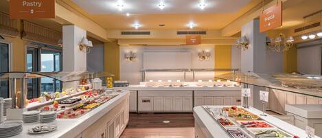 A buffet area with various food stations labeled 'World Pastry' and 'Fresca'.
