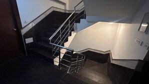 A staircase with metal railings and a landing area.