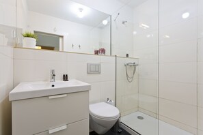 Shower, hair dryer, towels, toilet paper