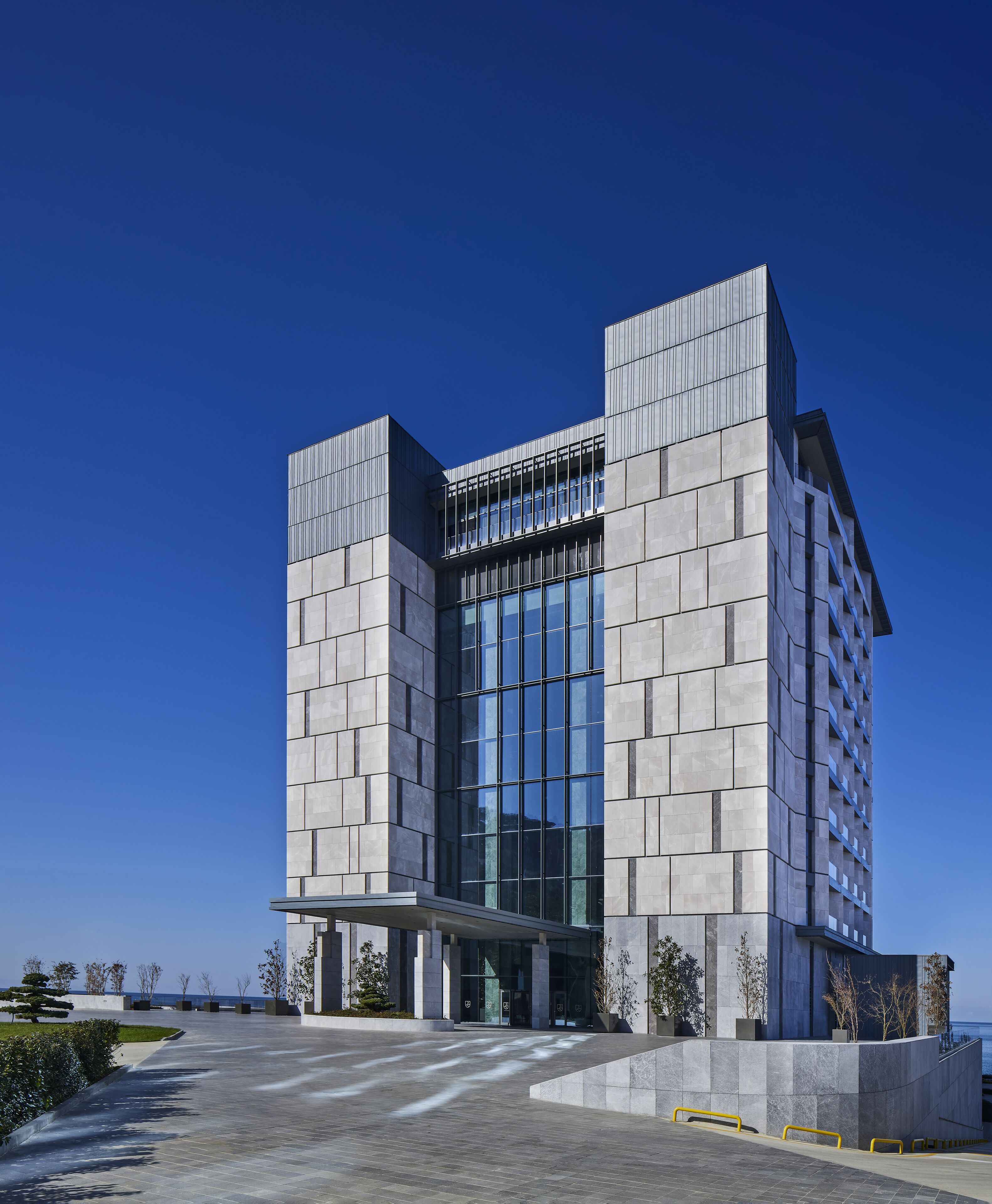 A modern building with a symmetrical facade, large windows, and a central entrance.