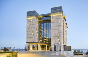 A modern building with a glass facade and a structured, geometric design.