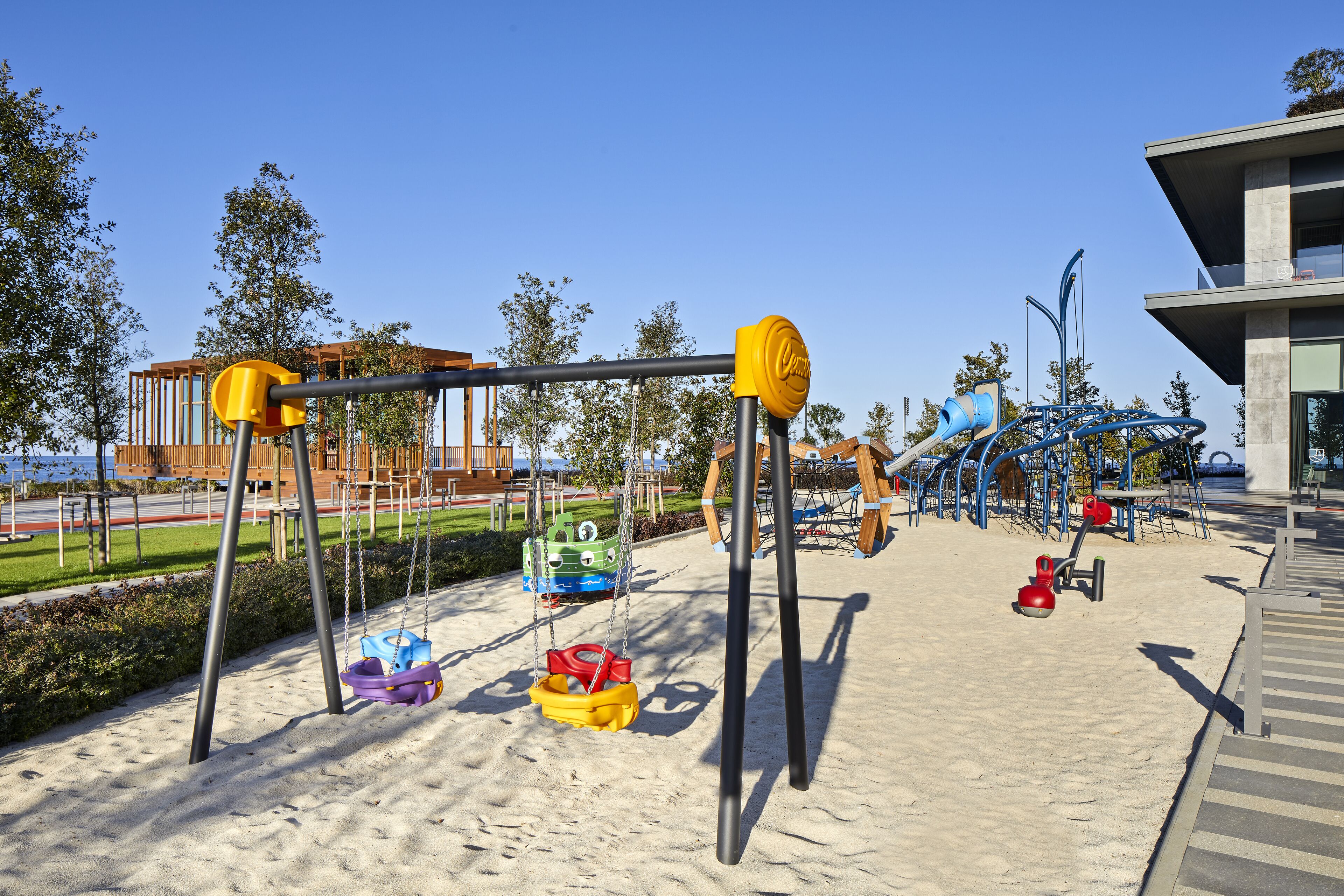 A playground with swings, slides, and sand play area.