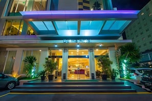 A hotel entrance with a modern design, featuring a glass facade and a sign that reads 'Dama Hotel'. - Daima Hotel (Padang)