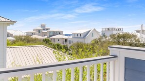 A coastal residential area with multiple white houses, a clear blue sky, and a wooden deck. - Amazing Place - 1232960 (Santa Rosa Beach)