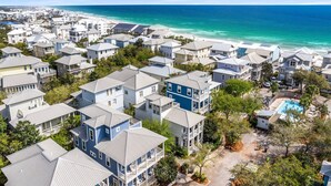 A coastal residential area with multiple two-story houses, a swimming pool, and a beach in the background. - Amazing Place - 1232960 (Santa Rosa Beach)